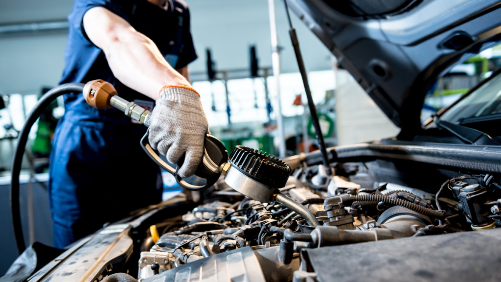 Mechanic performing car repairs in garage